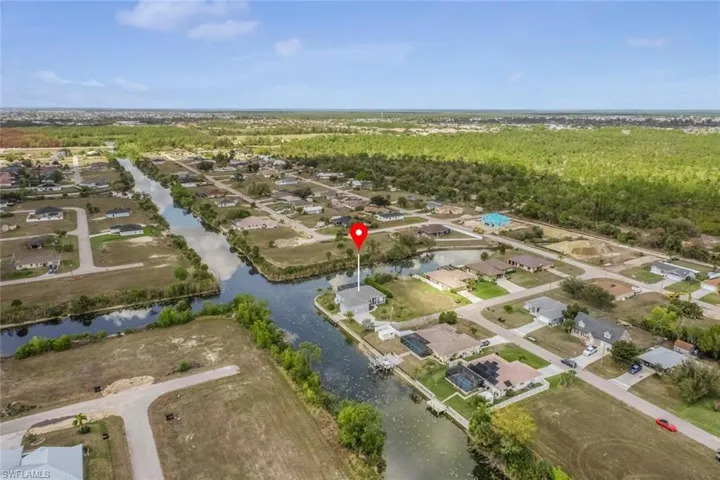 Aerial perspective of suburban area featuring a large body of water