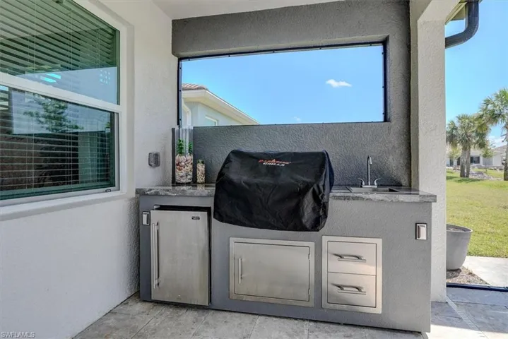 View of patio / terrace with a sink, grilling area, and exterior kitchen