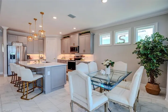 Kitchen with visible vents, gray cabinets, marble finish floor, and stainless steel appliances