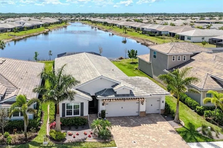 Birds eye view of property featuring a water view and a residential view