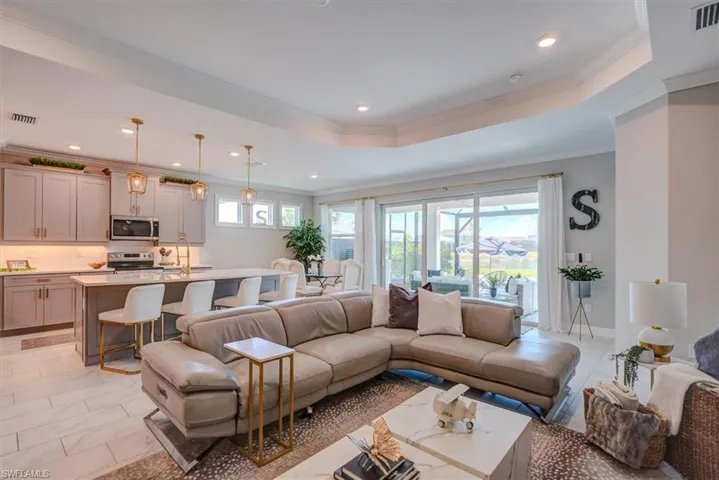 Living room with crown molding, visible vents, and recessed lighting