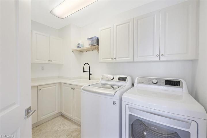 Large laundry room with sink, new washer & dryer.