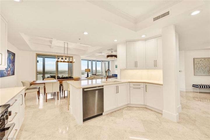 .Under counter lighting, modern gold hardware and quartz backsplash add to the drama of this PERFECT kitchen.