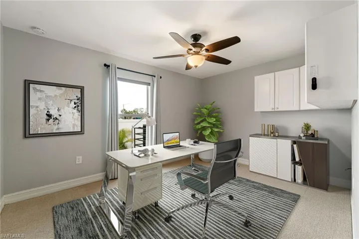 Home office with light carpet and ceiling fan