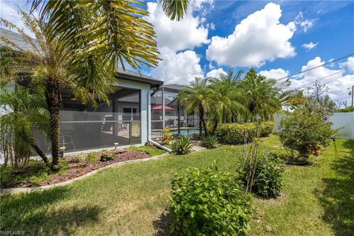 View of yard featuring a sunroom and a lanai