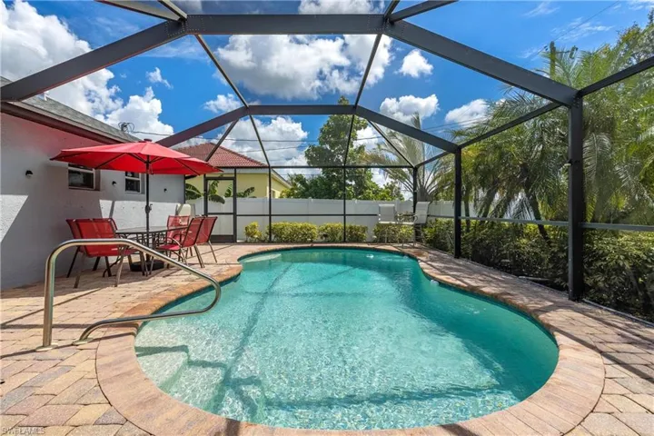 View of swimming pool with a lanai, a sunroom, and a patio