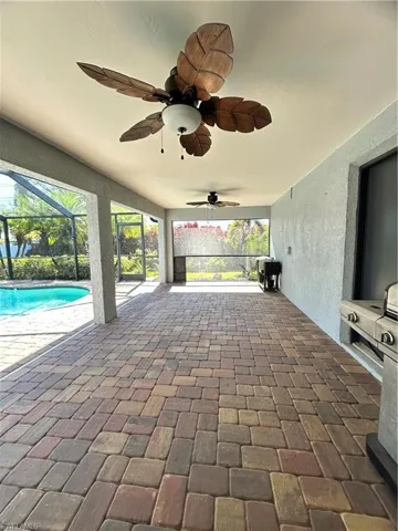 View of patio / terrace with a sunroom, a lanai, and ceiling fan