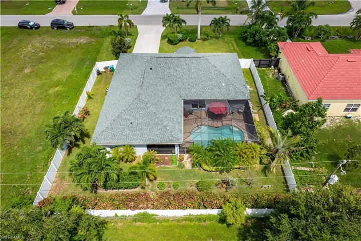 Aerial view of property and surrounding area featuring a pool