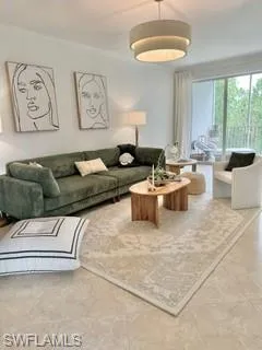 Living room featuring crown molding and tile patterned floors