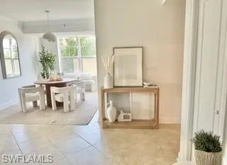 Tiled dining room featuring ornamental molding