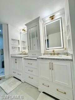 Bathroom featuring double vanity and tile patterned flooring