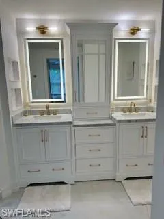 Bathroom featuring tile patterned flooring and dual bowl vanity