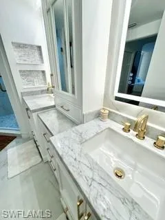 Bathroom featuring tile patterned flooring and vanity
