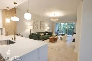 Kitchen with hanging light fixtures, sink, and tile patterned flooring