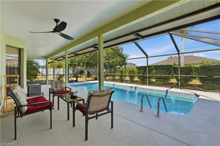 Swimming pool with a patio area, a lanai, and a sunroom
