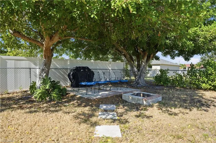 Fenced backyard with a patio