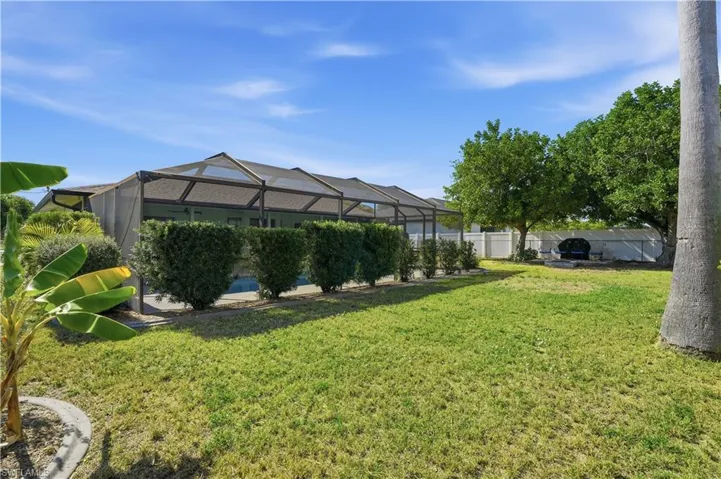 View of yard with a lanai and a sunroom
