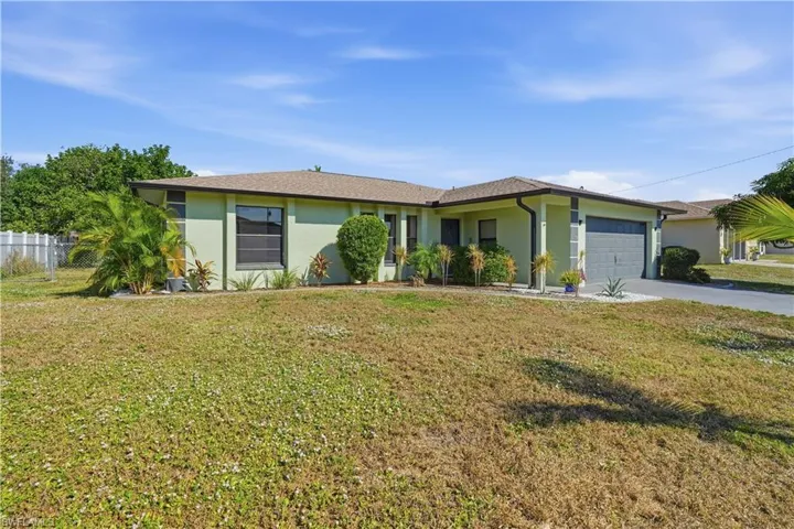 Ranch-style home featuring stucco siding, concrete driveway, and an attached garage