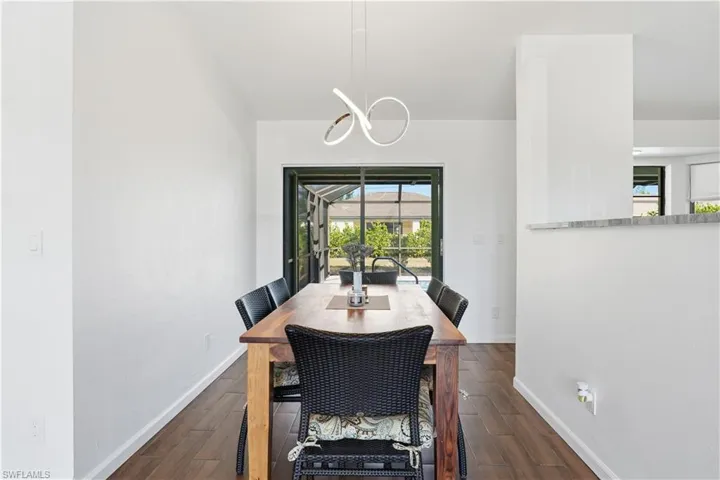 Dining space with dark wood finished floors and baseboards