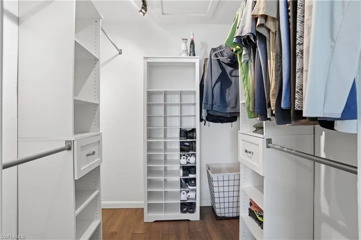 Walk in closet featuring dark wood-style floors