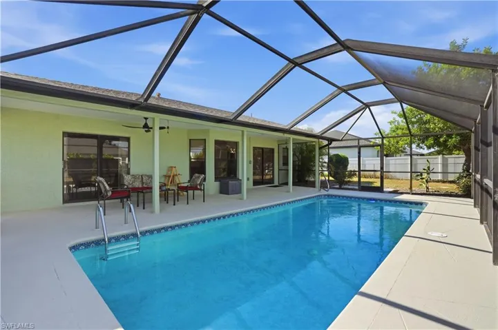 View of pool featuring a sunroom, a lanai, and a patio area