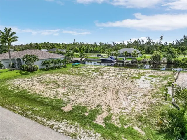 Birds eye view of property with a water view
