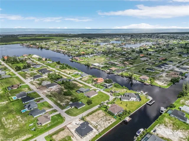 Birds eye view of property with a water view