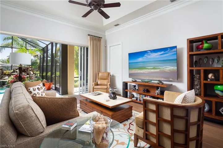 Living room featuring crown molding, ceiling fan, and hardwood / wood-style floors