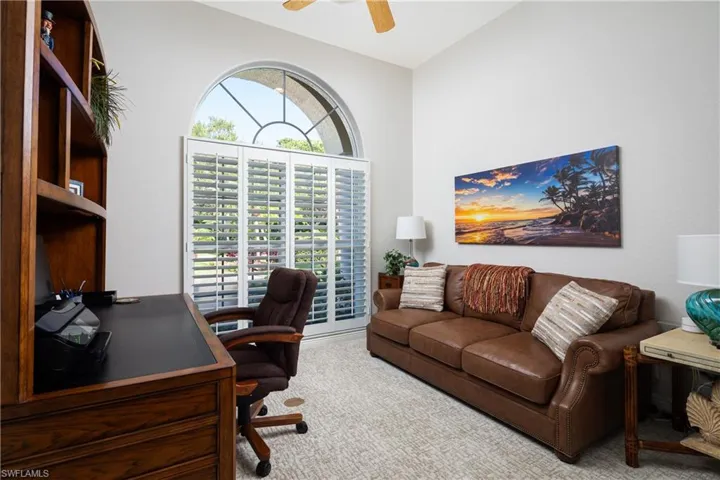 Office area featuring lofted ceiling, carpet, and ceiling fan