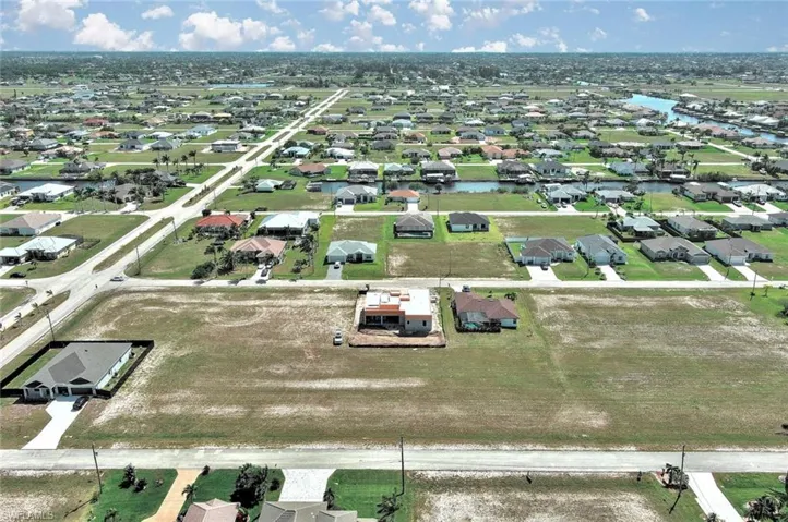 Aerial overview of property's location with a nearby body of water and nearby suburban area