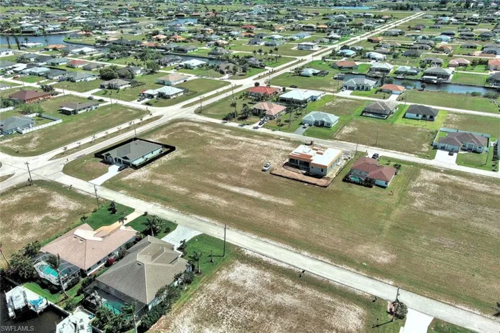 Aerial overview of property's location with a large body of water and nearby suburban area
