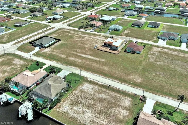 Aerial view of property's location featuring nearby suburban area and a large body of water