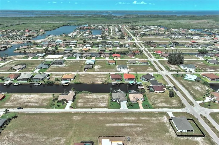 View of property location featuring a large body of water and nearby suburban area