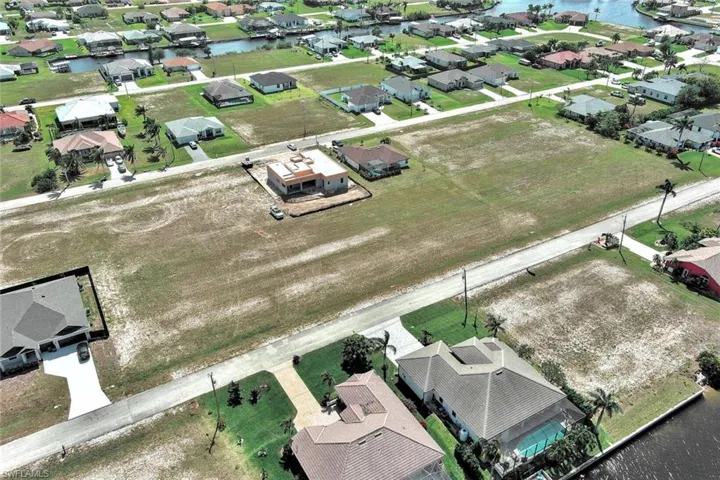 Aerial perspective of suburban area with a nearby body of water