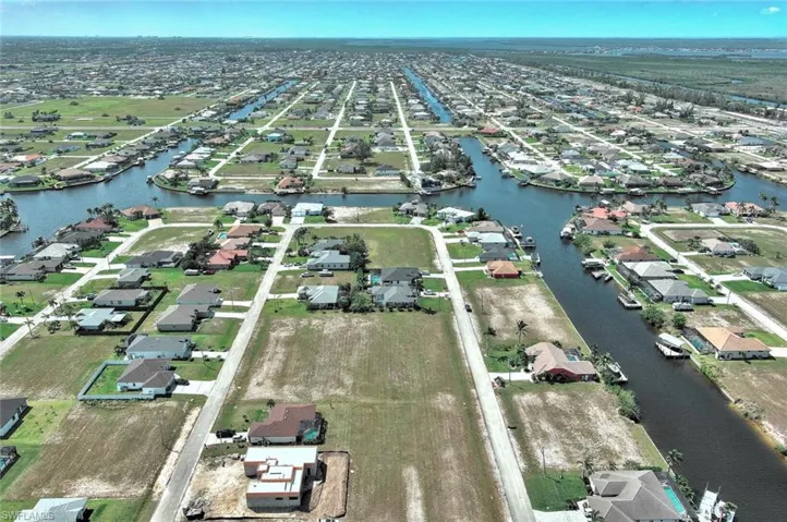 View of property location featuring a large body of water and nearby suburban area