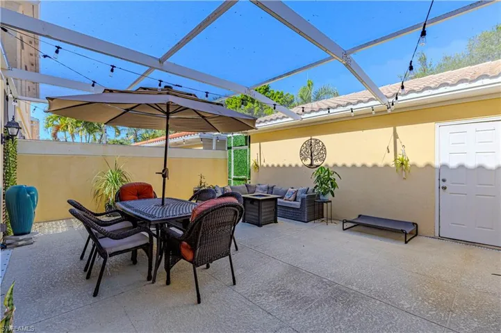 View of patio / terrace featuring an outdoor living / dining area and glass enclosure