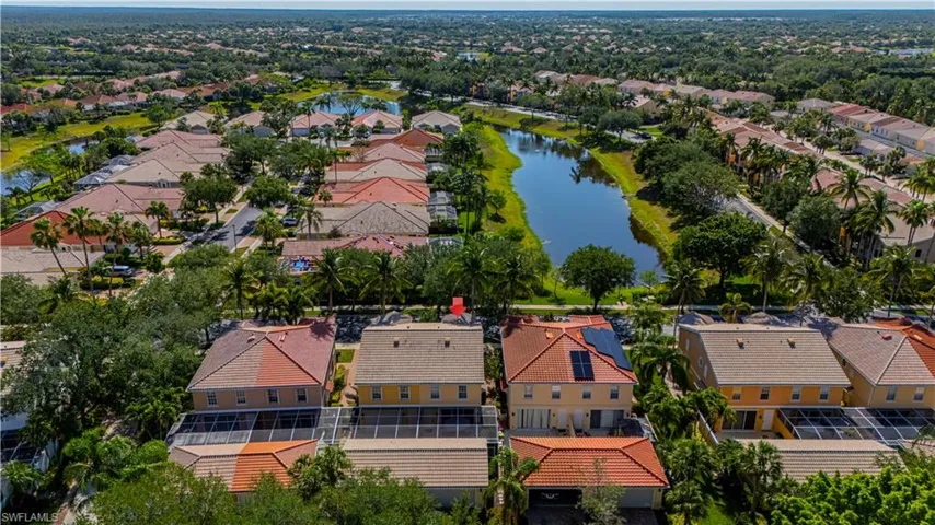Aerial perspective of suburban area featuring a nearby body of water