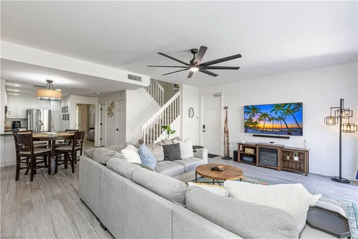 Living area with wood finish floors, a ceiling fan, and a textured ceiling