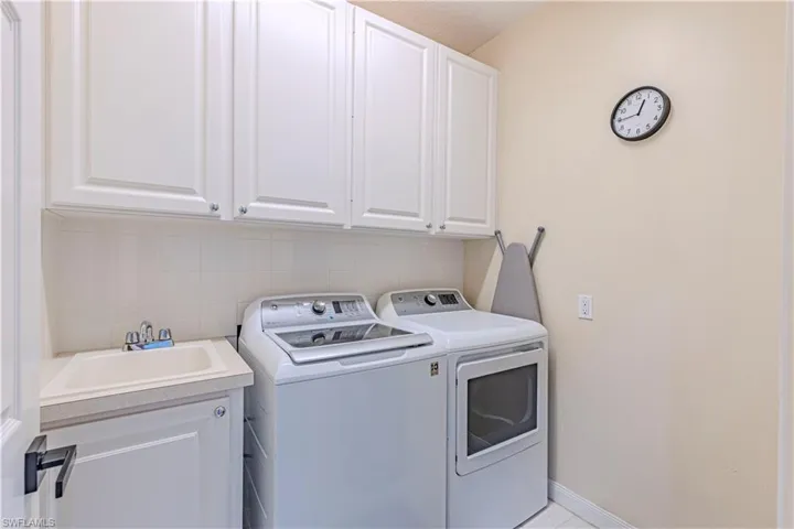 Laundry room featuring cabinet space and independent washer and dryer