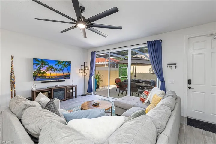 Living room with wood finished floors and a ceiling fan