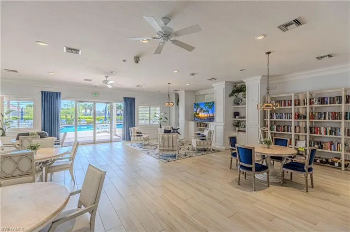 Dining area with crown molding, wood finish floors, ceiling fan, and a textured ceiling