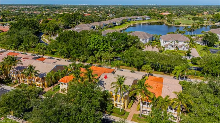 Aerial perspective of suburban area featuring a nearby body of water
