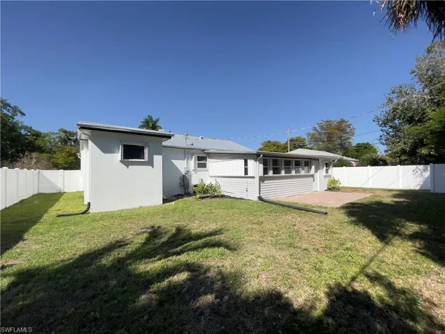 Back of house with a fenced backyard