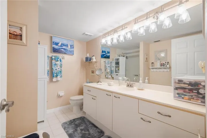 Bathroom with tile patterned flooring, vanity, and toilet