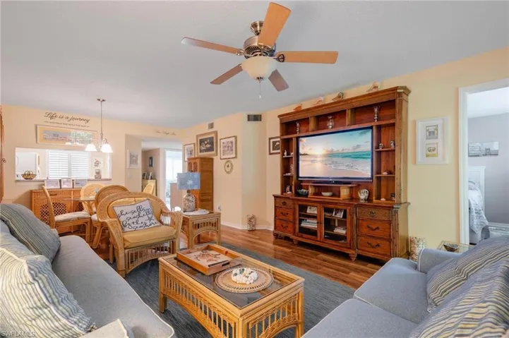 Living room featuring ceiling fan and dark hardwood / wood-style floors