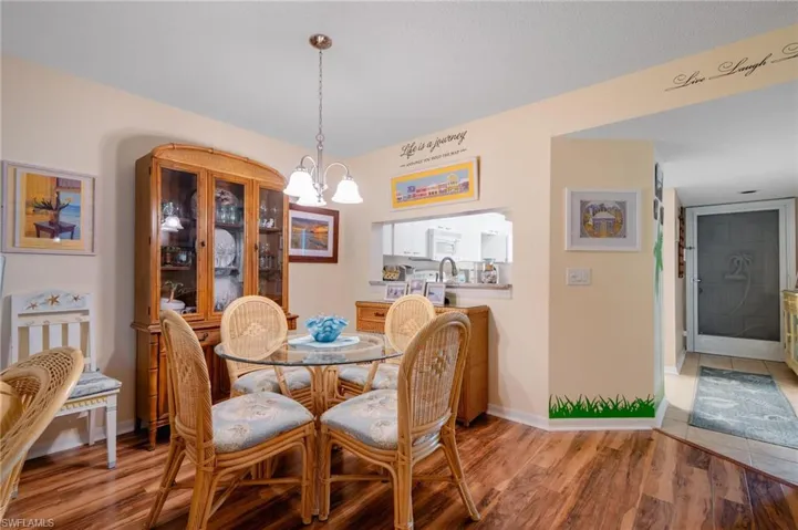 Dining area with light hardwood / wood-style flooring and a chandelier