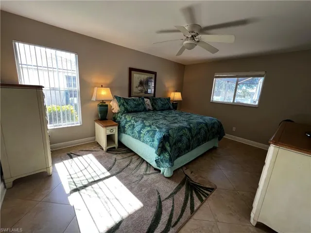 Bedroom featuring light tile patterned flooring and a ceiling fan