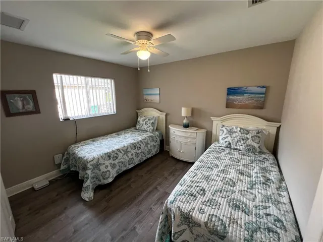 Bedroom with dark wood-type flooring and ceiling fan