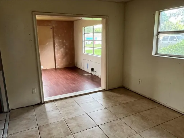 Empty room with a healthy amount of sunlight and hardwood / wood-style flooring