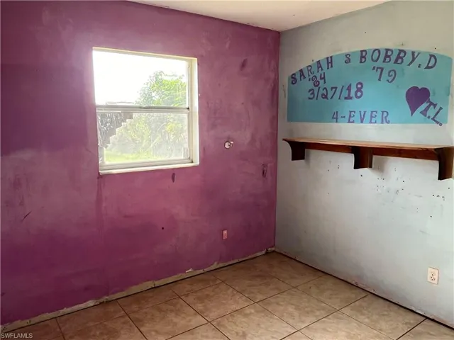 Unfurnished bedroom featuring light tile patterned floors